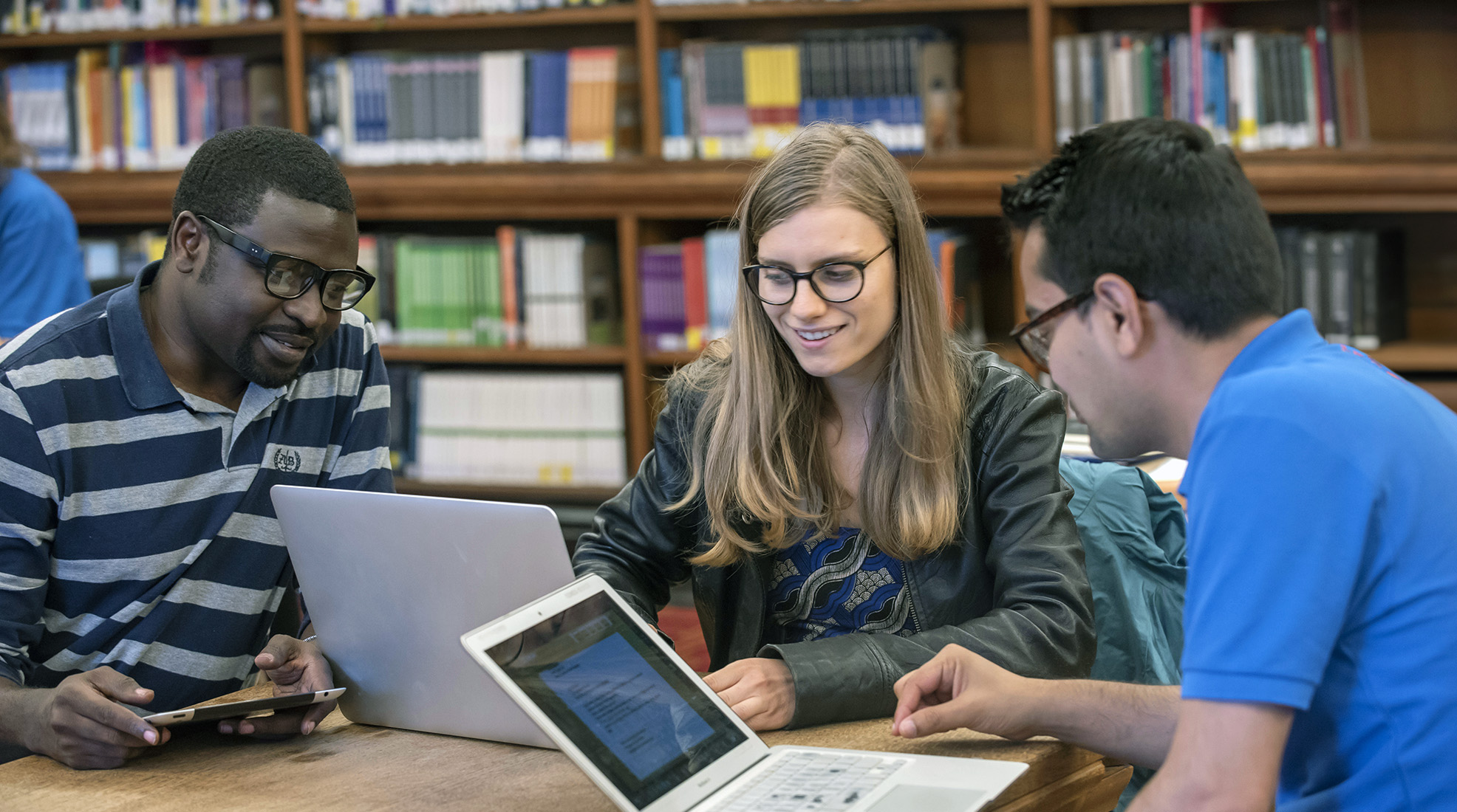 Master's students studying together in the library