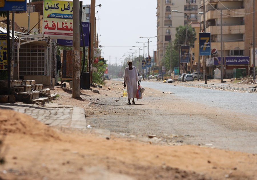 A man walks down a ruined street in war-torn Khartoum. Credit: Faiz Abubakr Mohamed. A man walks down a ruined street in war-torn Khartoum.